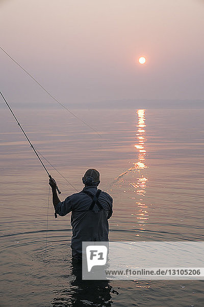 Senior Caucasian male fly fishing for salmon and sea run cutthroat trout off the coast