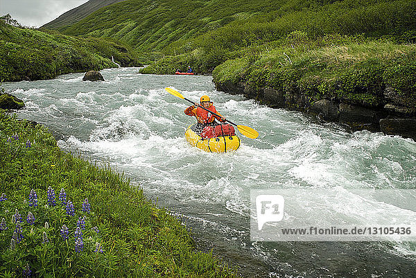 Woman Pack Rafts Down The Aniakchak River In Aniakchak National Monument And Preserve In Southwest Alaska