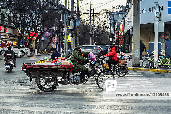 Vehicle carrying fruits and vegetables in the streets of Xian; Xian  Shaanxi Province  China