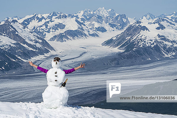 Snowman with arms and champagne bottle on a mountain top in Kluane National Park and Reserve; Haines Junction  Yukon  Canada