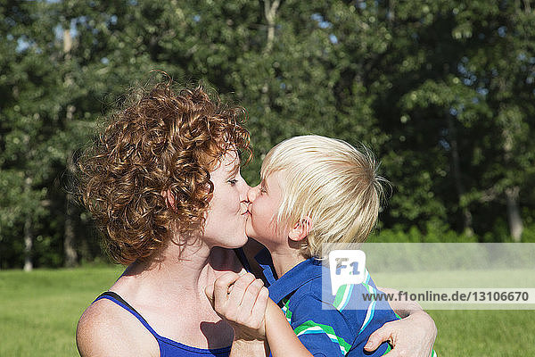 A Mother Holds And Kisses Her Young Son; Stony Plain  Alberta  Canada