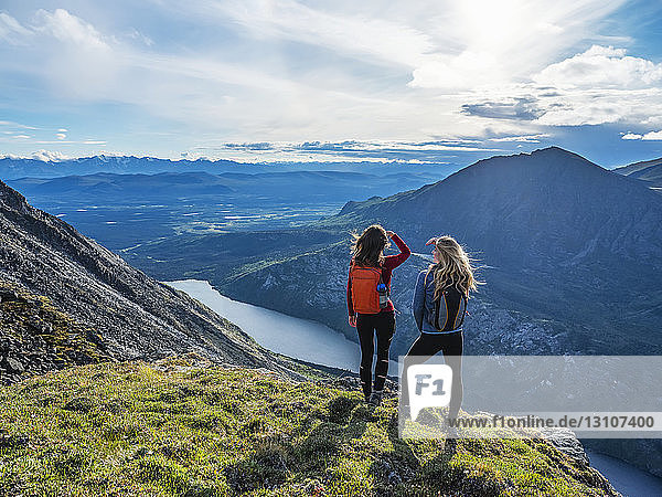 Two women exploring the mountains and wilderness of the Yukon. Feeling alive and vibrant in the beautiful scenery around Haines Junction; Yukon  Canada