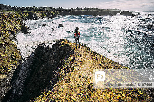 A woman stands looking out along the Russian Gulch Headlands  Mendocino county; California  United States of America