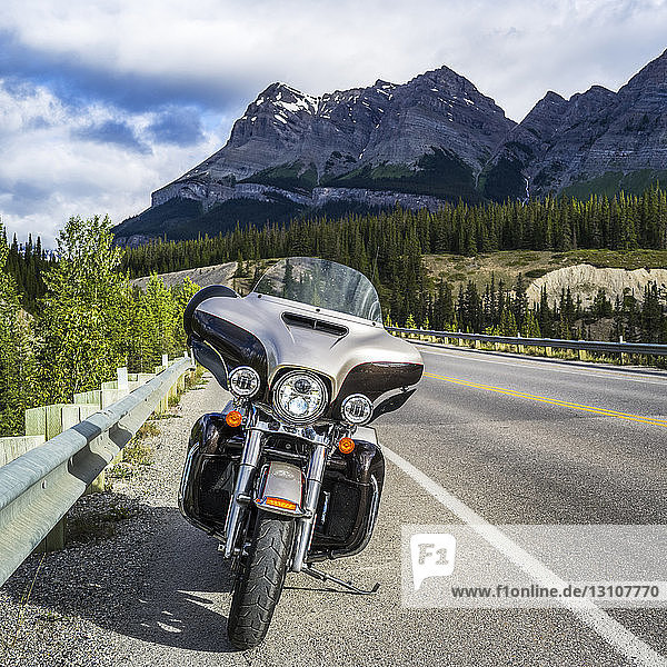 Motorcycle parked on the side of a road through the rugged Canadian Rocky Mountains in Jasper National Park; Alberta  Canada