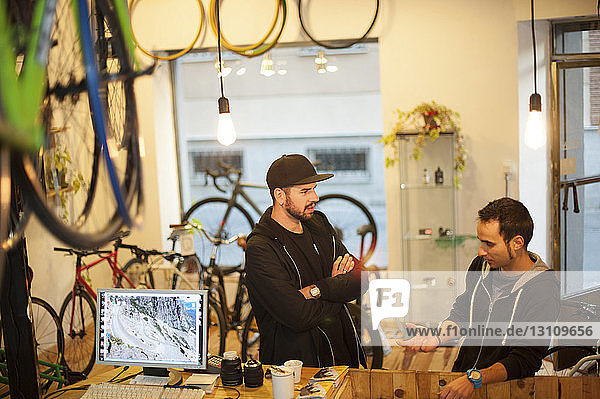 Friends talking at bicycle workshop