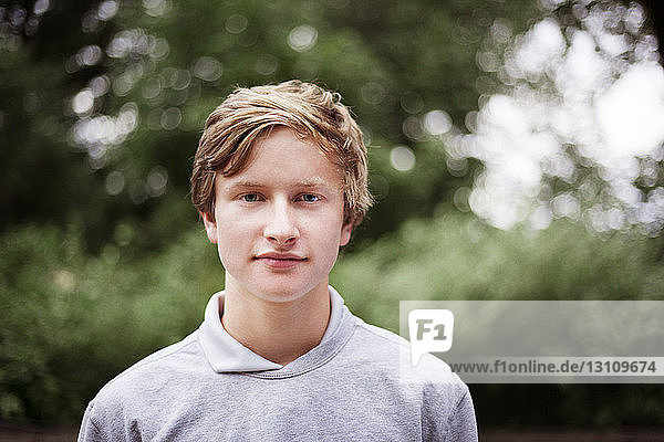 Portrait of smiling teenage boy outdoors