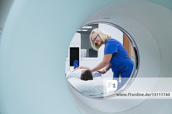 Nurse preparing patient for MRI Scan in hospital