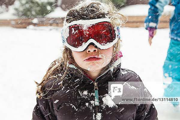 Girl wearing ski goggles during winter