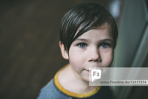 High angle portrait of confident boy at home