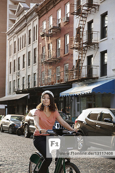Businesswoman riding bicycle on street