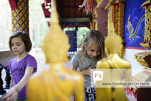 Girls praying at Buddhist temple