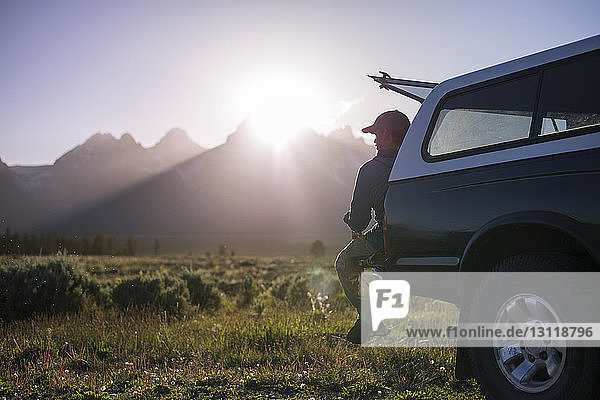 Man looking away while sitting on off-road vehicle at Grand Teton National Park