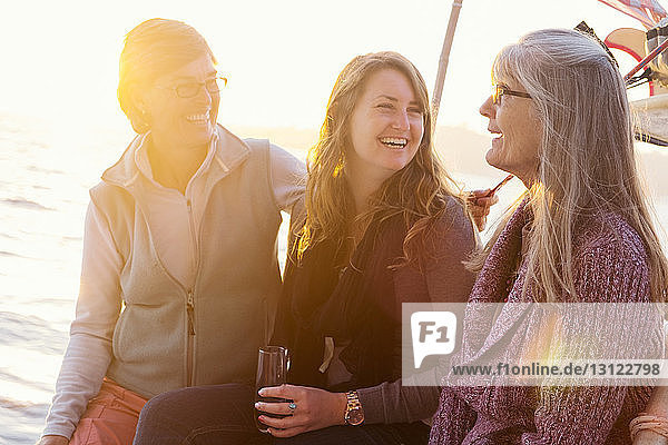 Happy women enjoying on boat in river