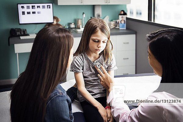 Girl being examined by female doctor in clinic