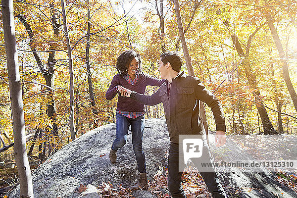 Couple enjoying in forest during autumn