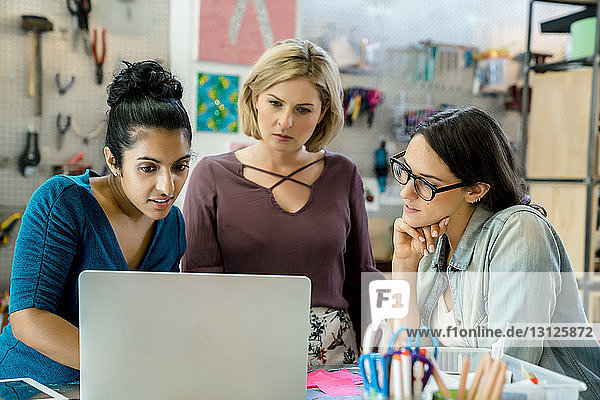 Businesswomen working on laptop computer in office