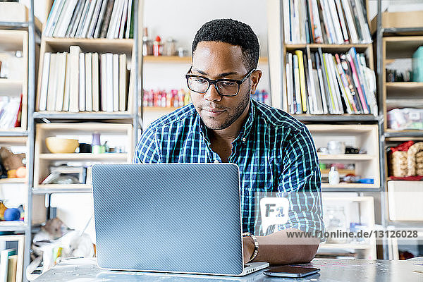 Businessman working on laptop computer in office