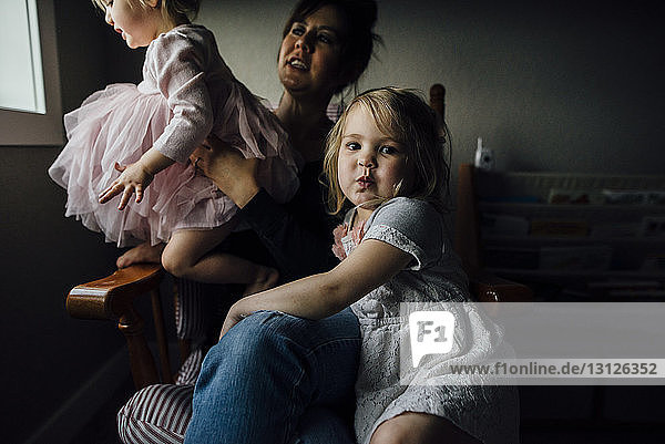 Portrait of cute girl sitting with mother and sister