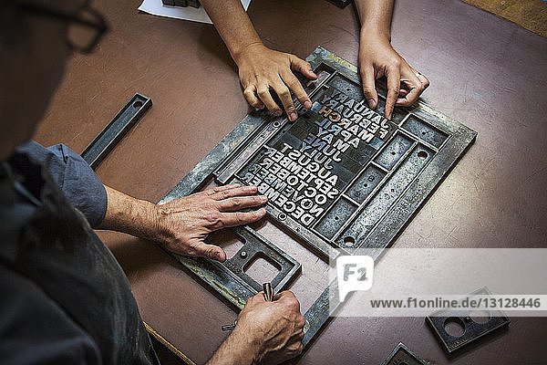 Man working on letterpress in workshop