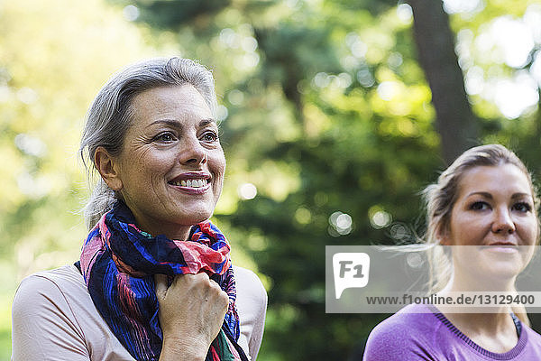 Close-up of female friends looking away at park