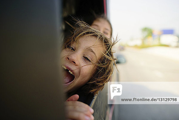Cheerful leaning on vehicle window