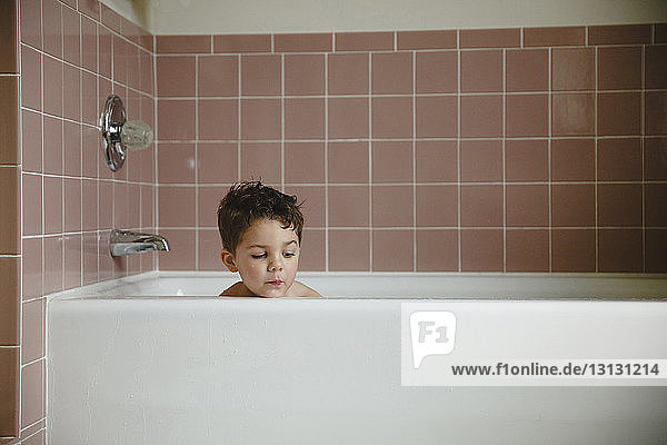Boy in bathtub at home