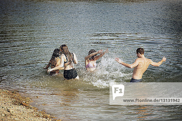 Playful friends enjoying in lake