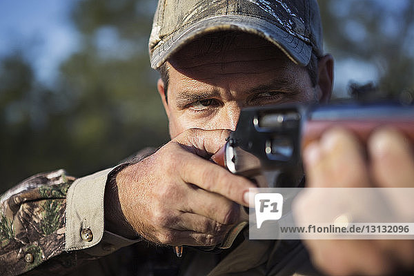 Close-up of man hunting with rifle