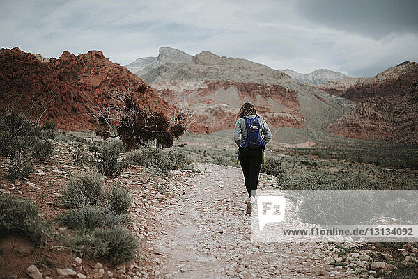 Rückansicht eines Wanderers mit Rucksack beim Wandern im Red Rock Canyon National Conservation Area