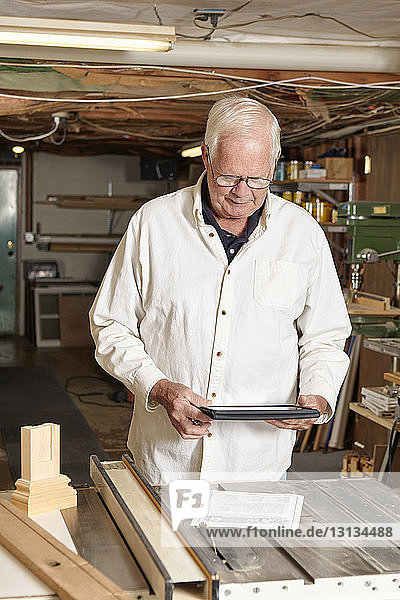 Man using tablet computer in workshop