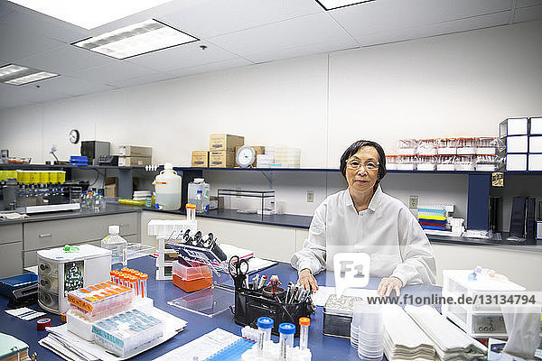 Portrait of confident senior female scientist in laboratory