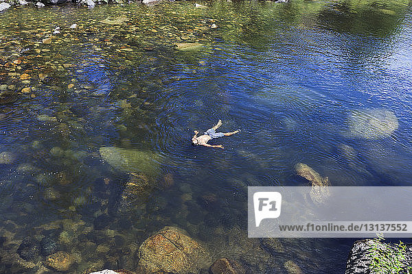 High angle view of man floating on water