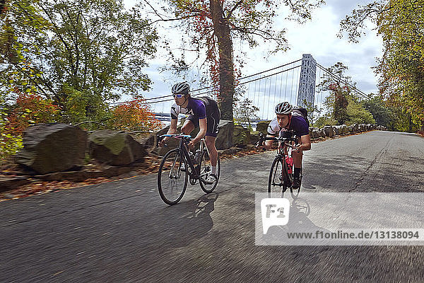 Cyclists racing on bicycle by George Washington Bridge