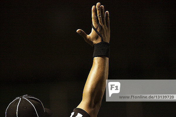 Cropped image of American football referee signaling touchdown