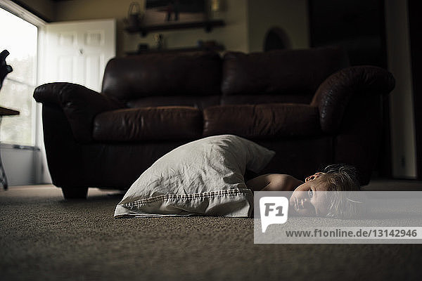 Boy relaxing on floor at home