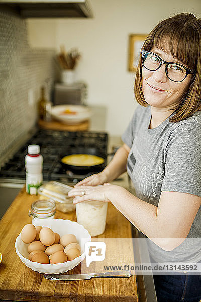 Porträt einer Frau  die zu Hause Essen zubereitet