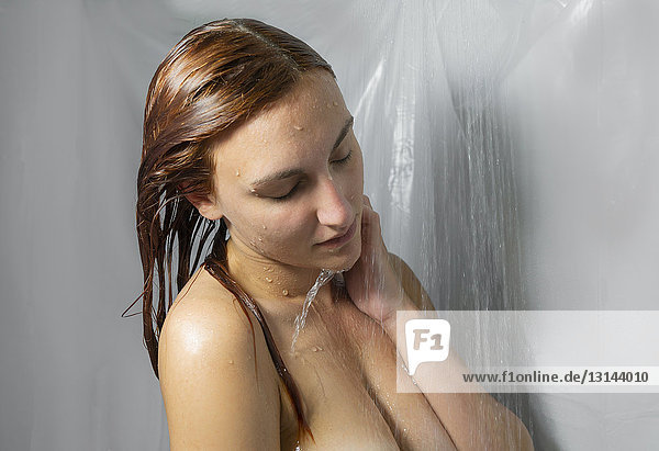 Junge Frau unter der Dusche