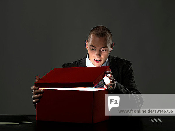 Business man opening box