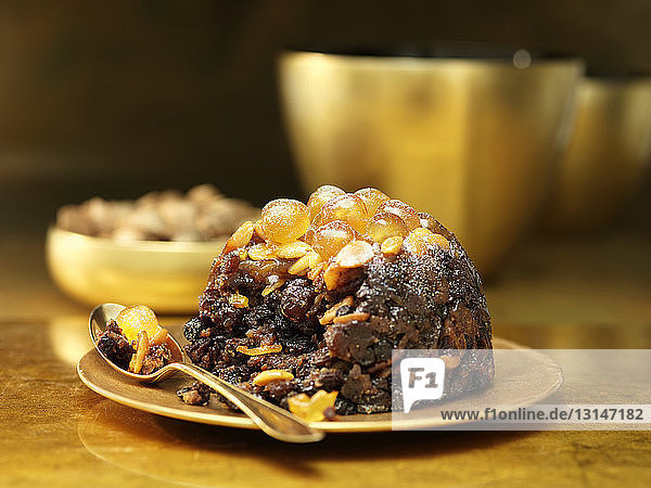 Christmas pudding on gold ceramic plate