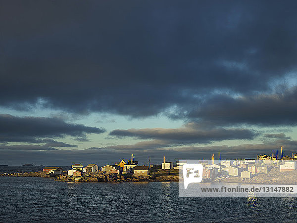 Blick auf die Uferpromenade des Dorfes und den dramatischen Himmel über Fogo Island  Neufundland  Kanada
