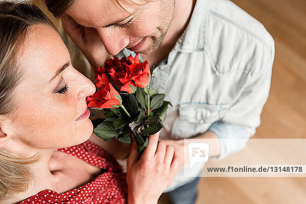 Man giving woman roses high angle
