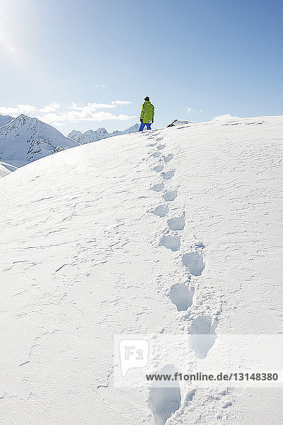 Man standing in snow with footprints  Kuhtai  Austria