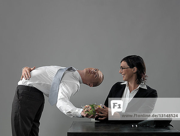 Business man serving lunch to colleague