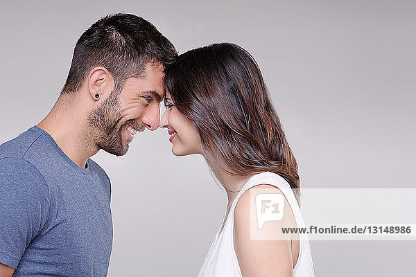 Portrait of heterosexual couple  face to face  smiling