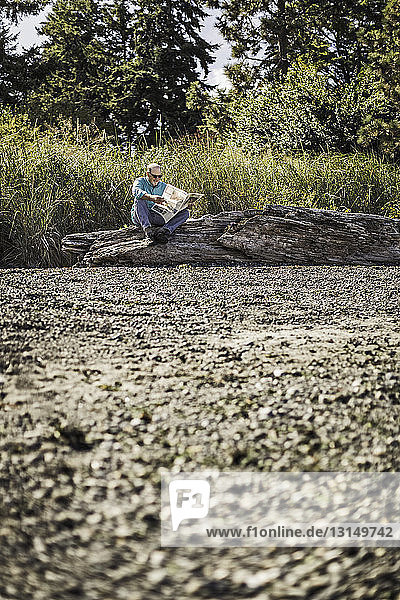 Senior man reading newspapers  Port Townsend  Washington  US
