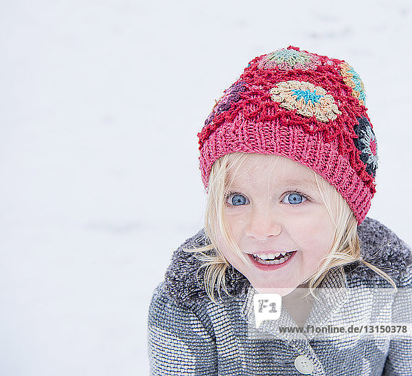 Happy toddler with colourful beanie