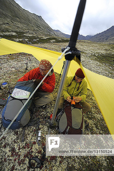 Wanderer packen im Zelt aus