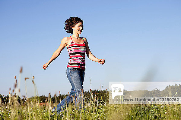 Woman Running Through Meadow