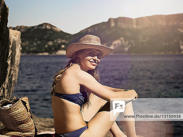 Smiling woman sitting on beach