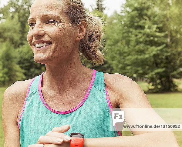 Mature woman working out outdoors smiling